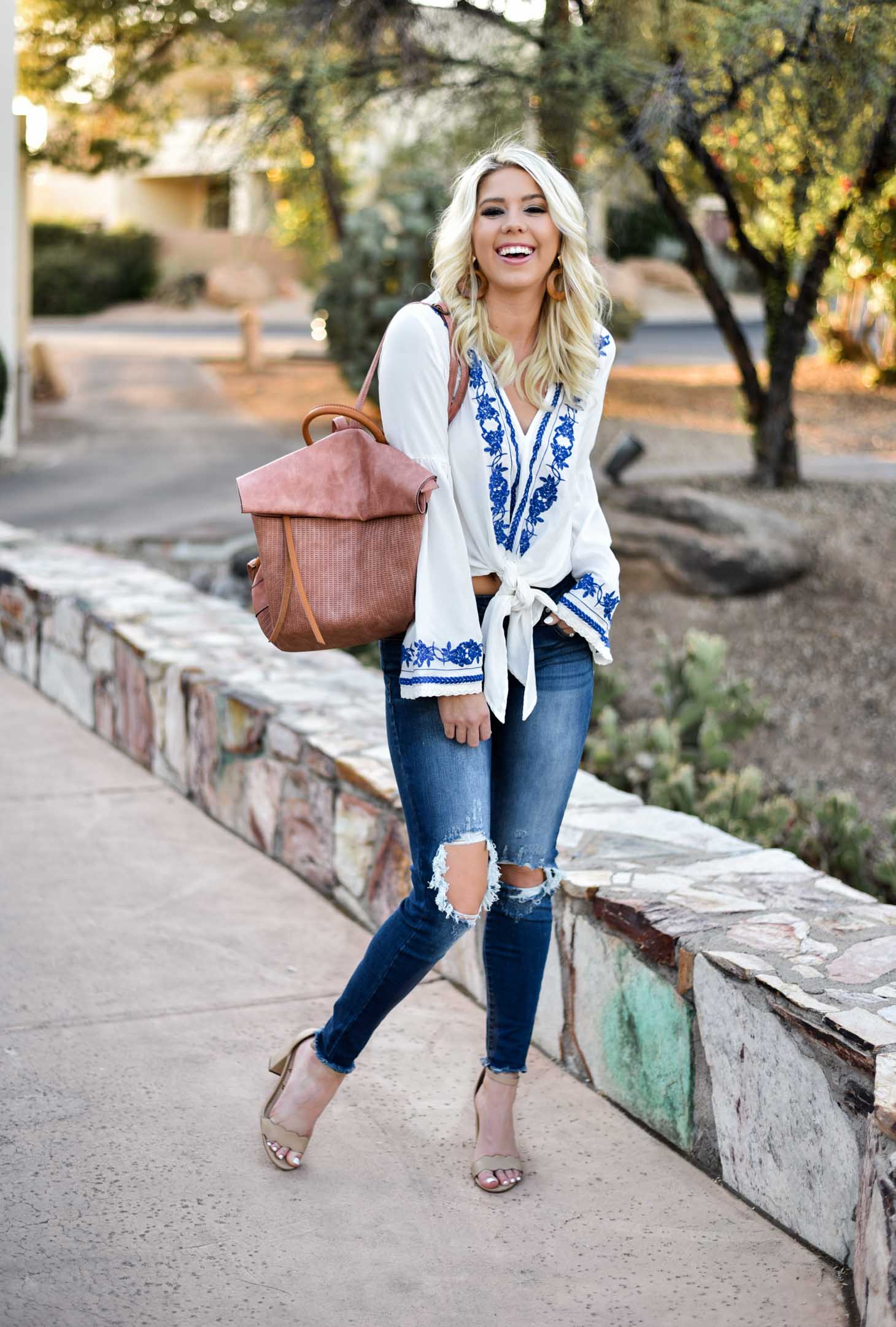 Erin Elizabeth of Wink and a Twirl in this Vici Dolls embroidered top jeans and blush backpack style perfect for summer