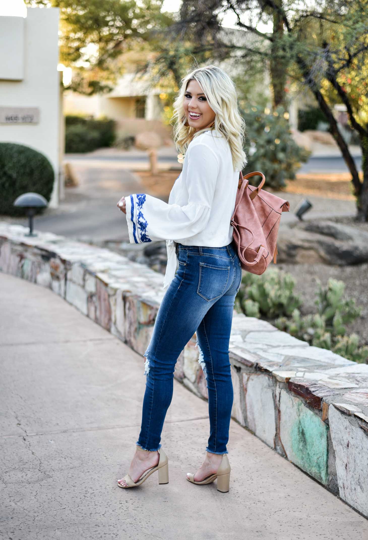 Erin Elizabeth of Wink and a Twirl in this Vici Dolls embroidered top jeans and blush backpack style perfect for summer