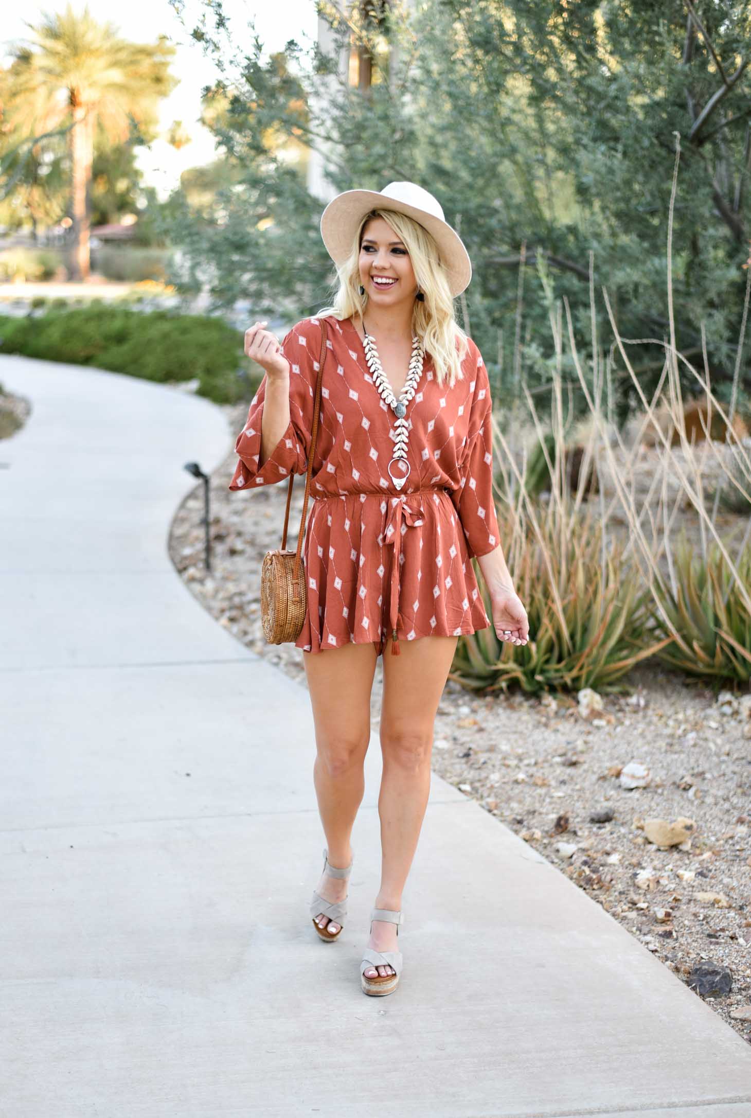 Erin Elizabeth of Wink and a Twirl I'm this summer romper from Red Dress Boutique