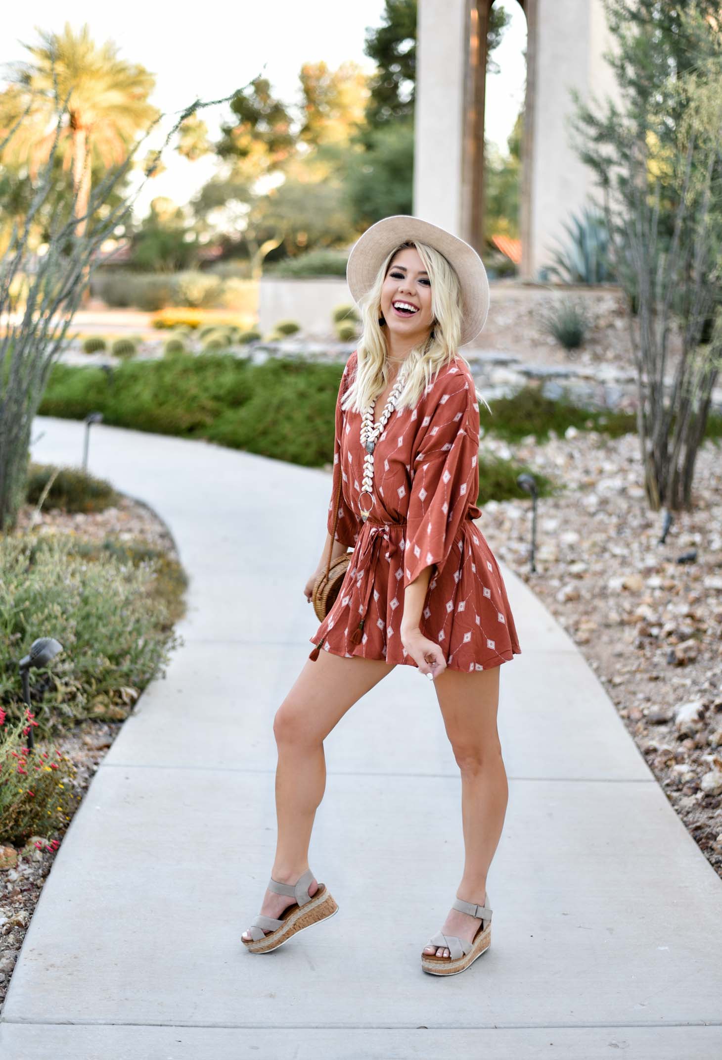 Erin Elizabeth of Wink and a Twirl I'm this summer romper from Red Dress Boutique