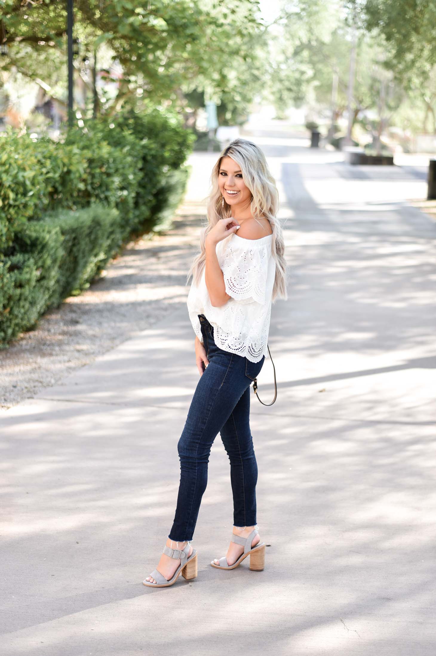 Erin Elizabeth of Wink and a Twirl shares the cutest white eyelet off the shoulder top from Jess Lea Boutique