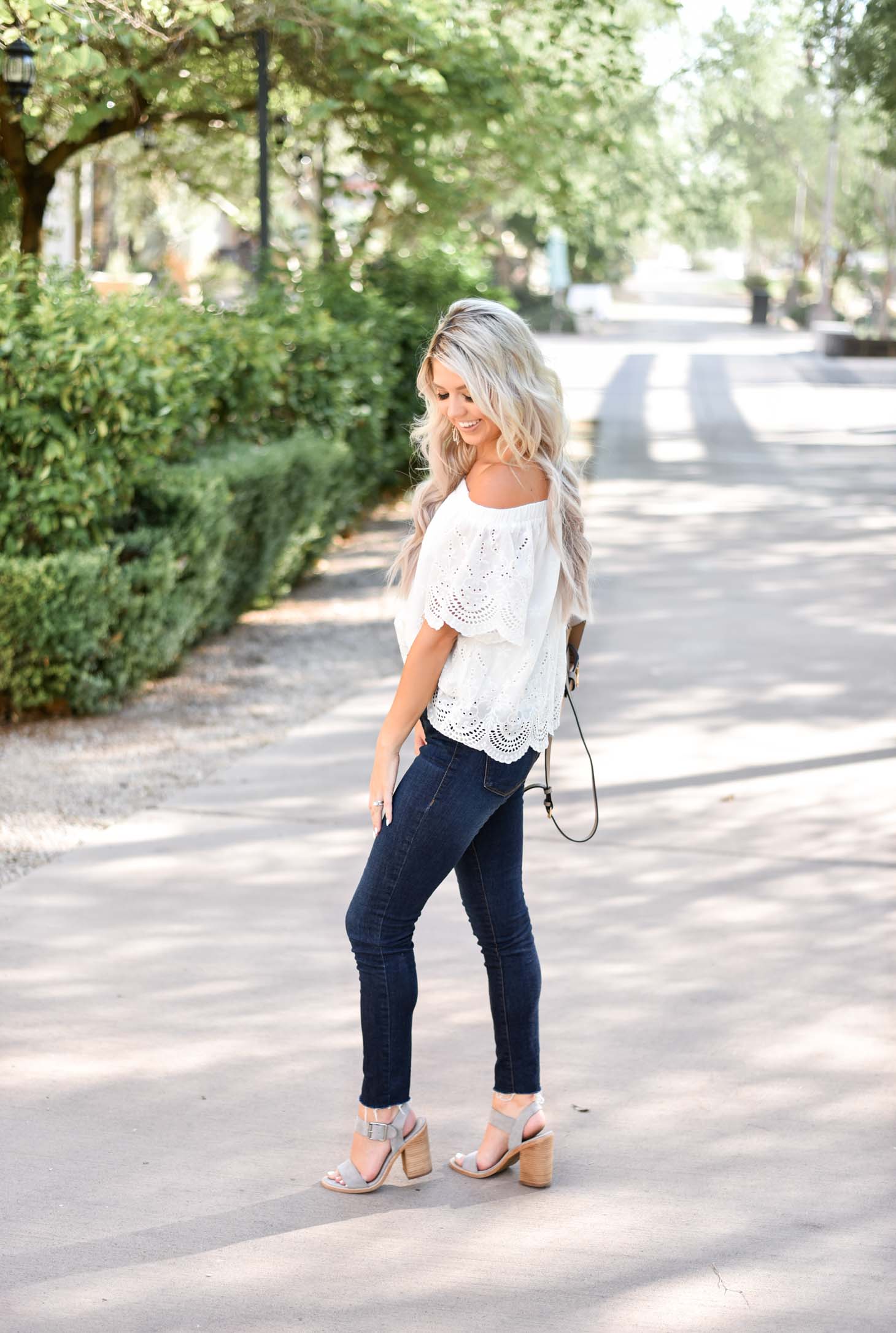 Erin Elizabeth of Wink and a Twirl shares the cutest white eyelet off the shoulder top from Jess Lea Boutique