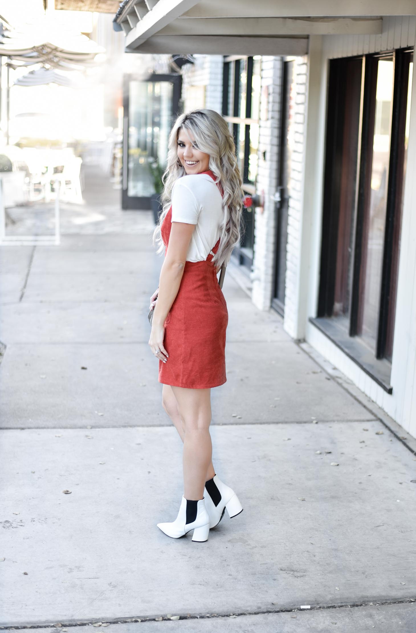 Erin Elizabeth of Wink and a Twirl share the cutest fall look with Red Dress Boutique Fall Jumper and White Booties