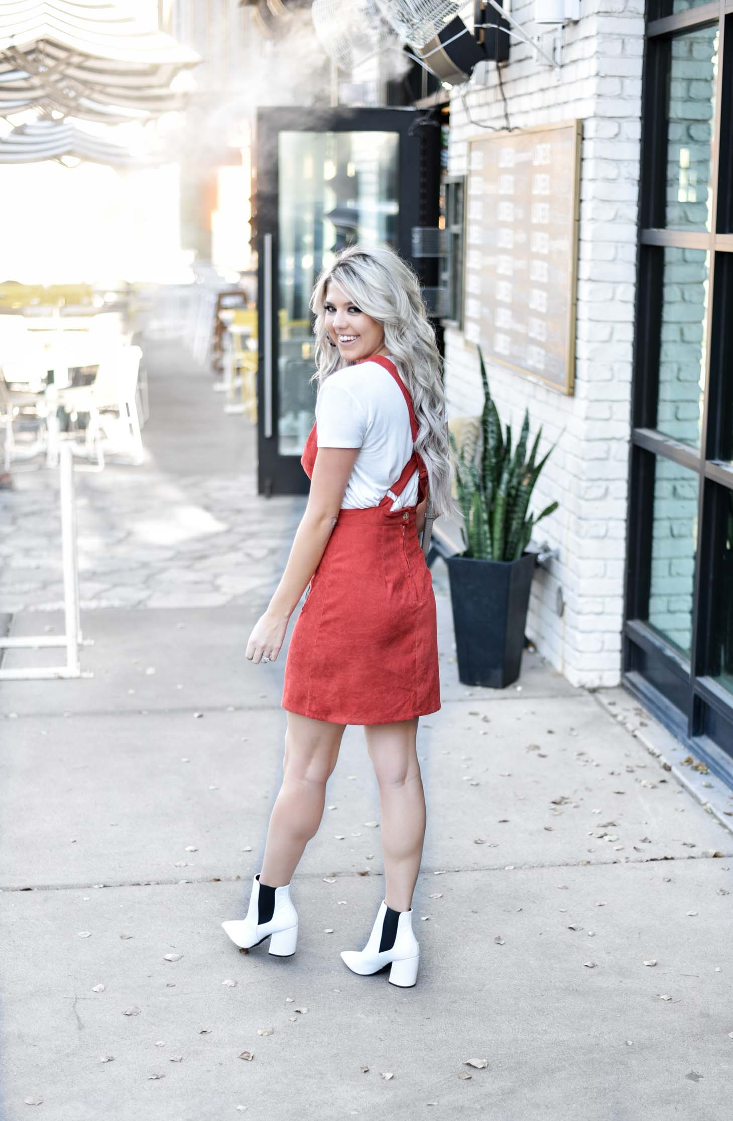 Erin Elizabeth of Wink and a Twirl share the cutest fall look with Red Dress Boutique Fall Jumper and White Booties