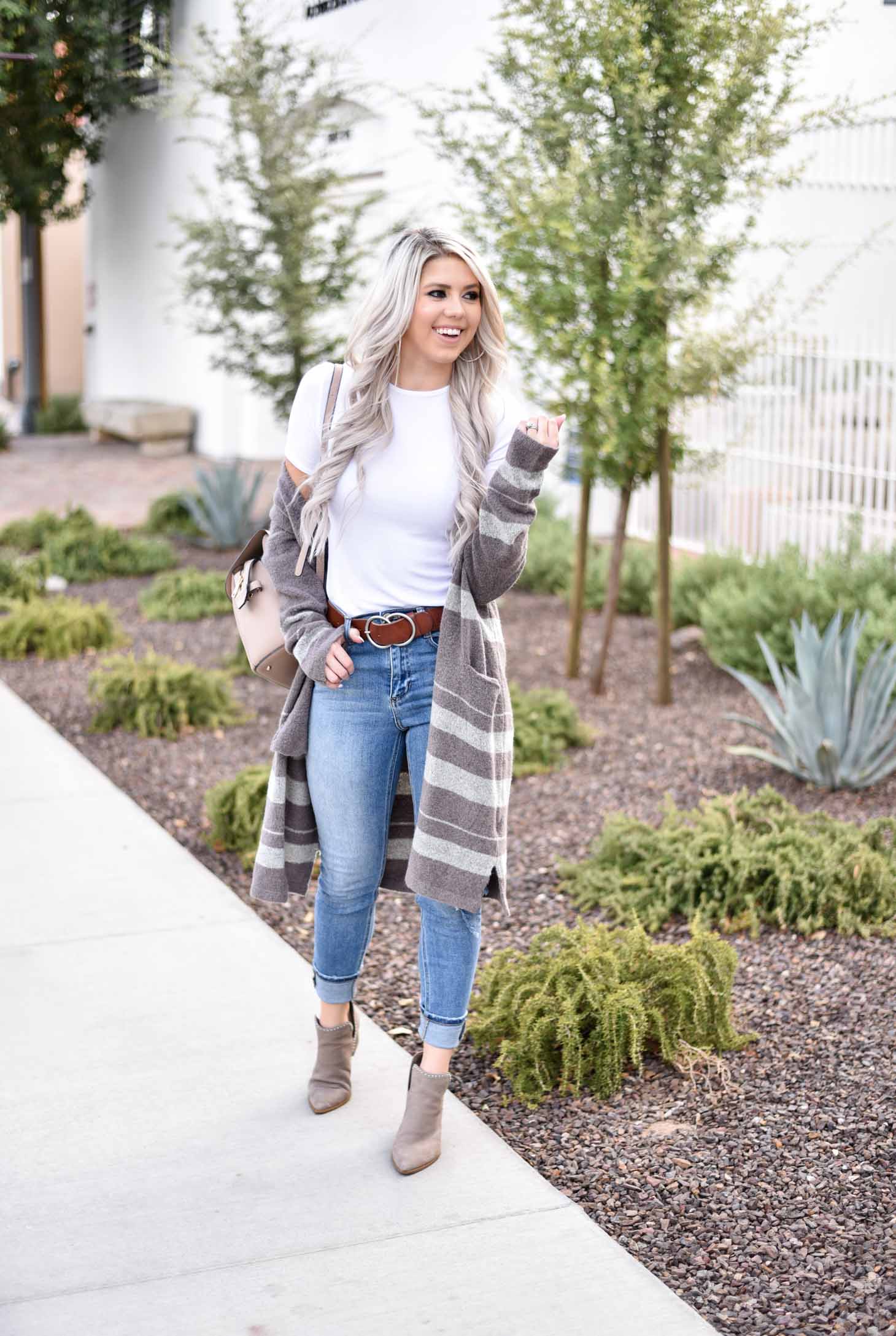 Erin Elizabeth of Wink and a Twirl share the cutest brown and white striped cardigan from Shop Sweet Olive perfect for layering this fall