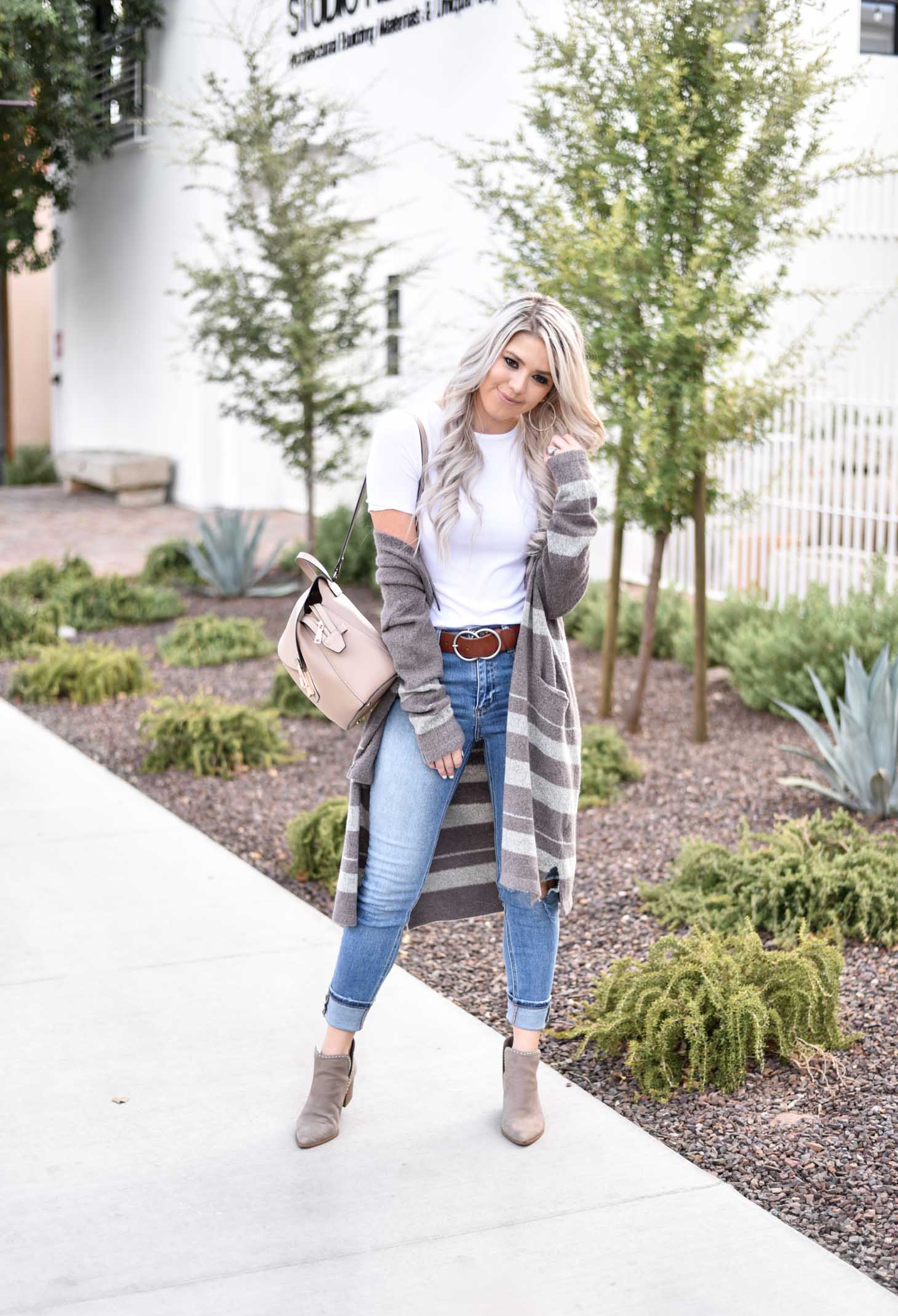 Erin Elizabeth of Wink and a Twirl share the cutest brown and white striped cardigan from Shop Sweet Olive perfect for layering this fall