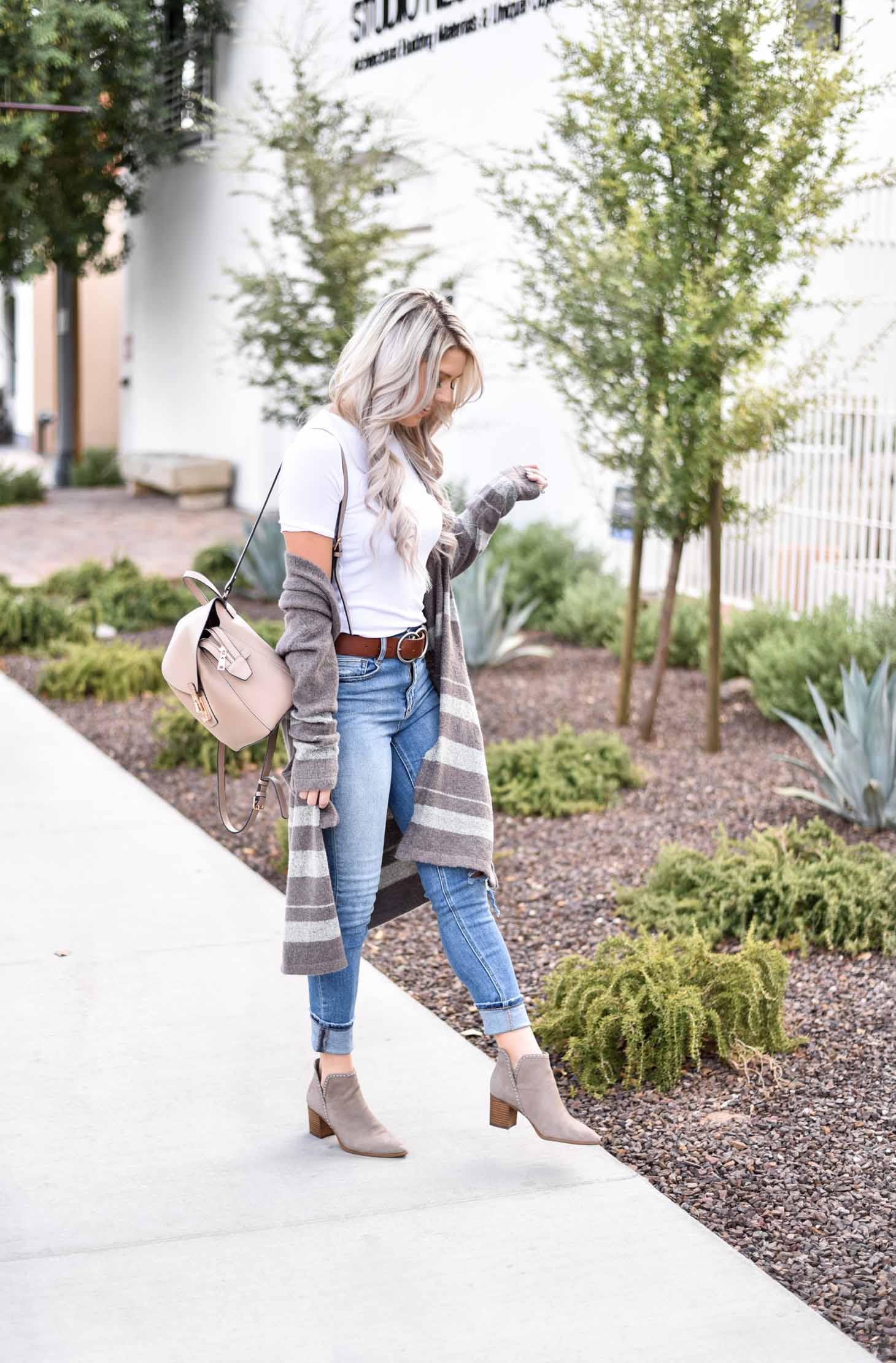 Erin Elizabeth of Wink and a Twirl share the cutest brown and white striped cardigan from Shop Sweet Olive perfect for layering this fall