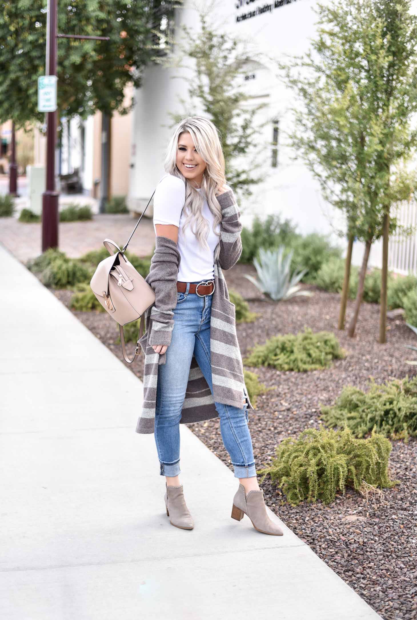 Erin Elizabeth of Wink and a Twirl share the cutest brown and white striped cardigan from Shop Sweet Olive perfect for layering this fall