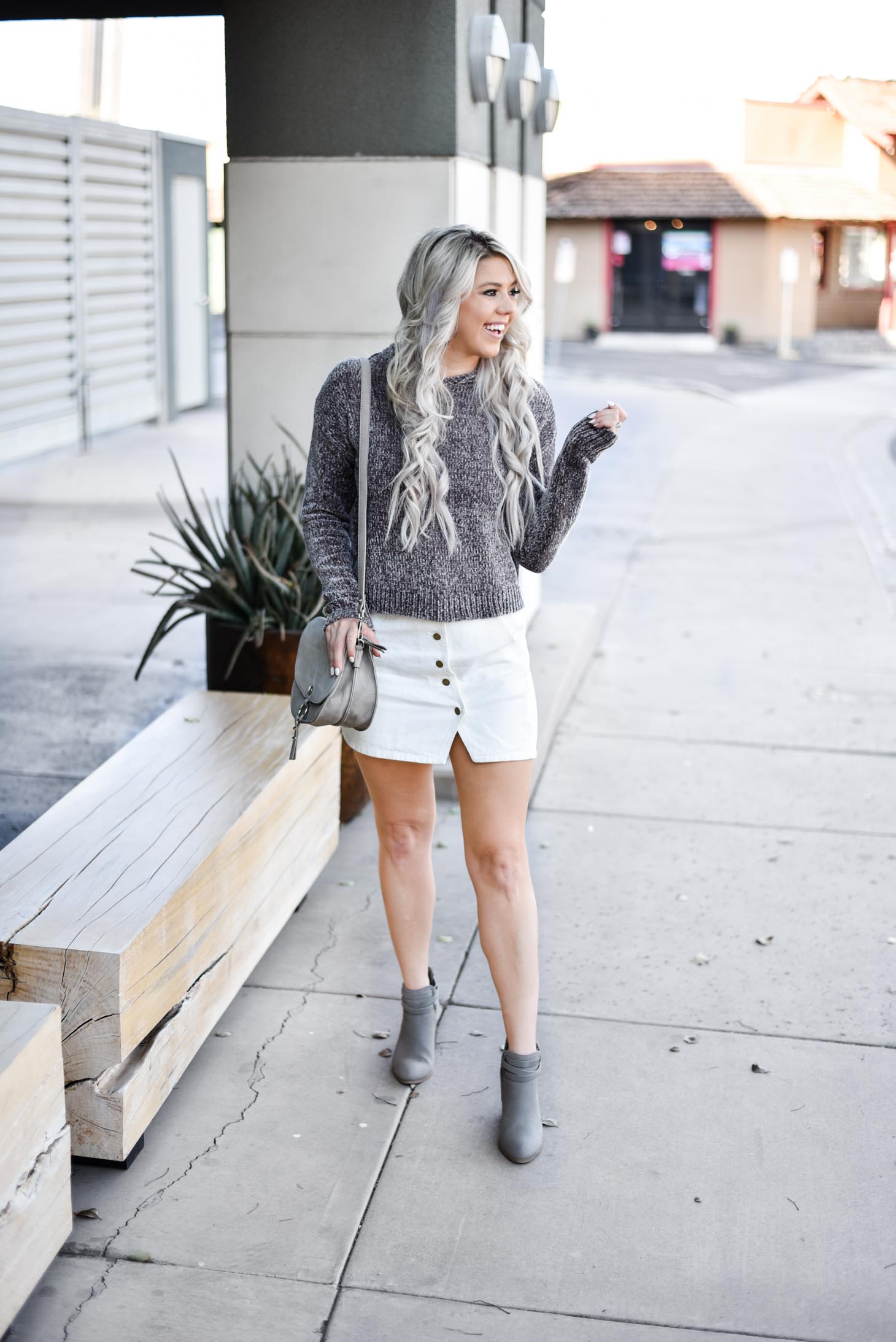 Erin Elizabeth of Wink and a Twirl shares a fall look from Red Dress Boutique with a cute hooded sweater and white miniskirt 