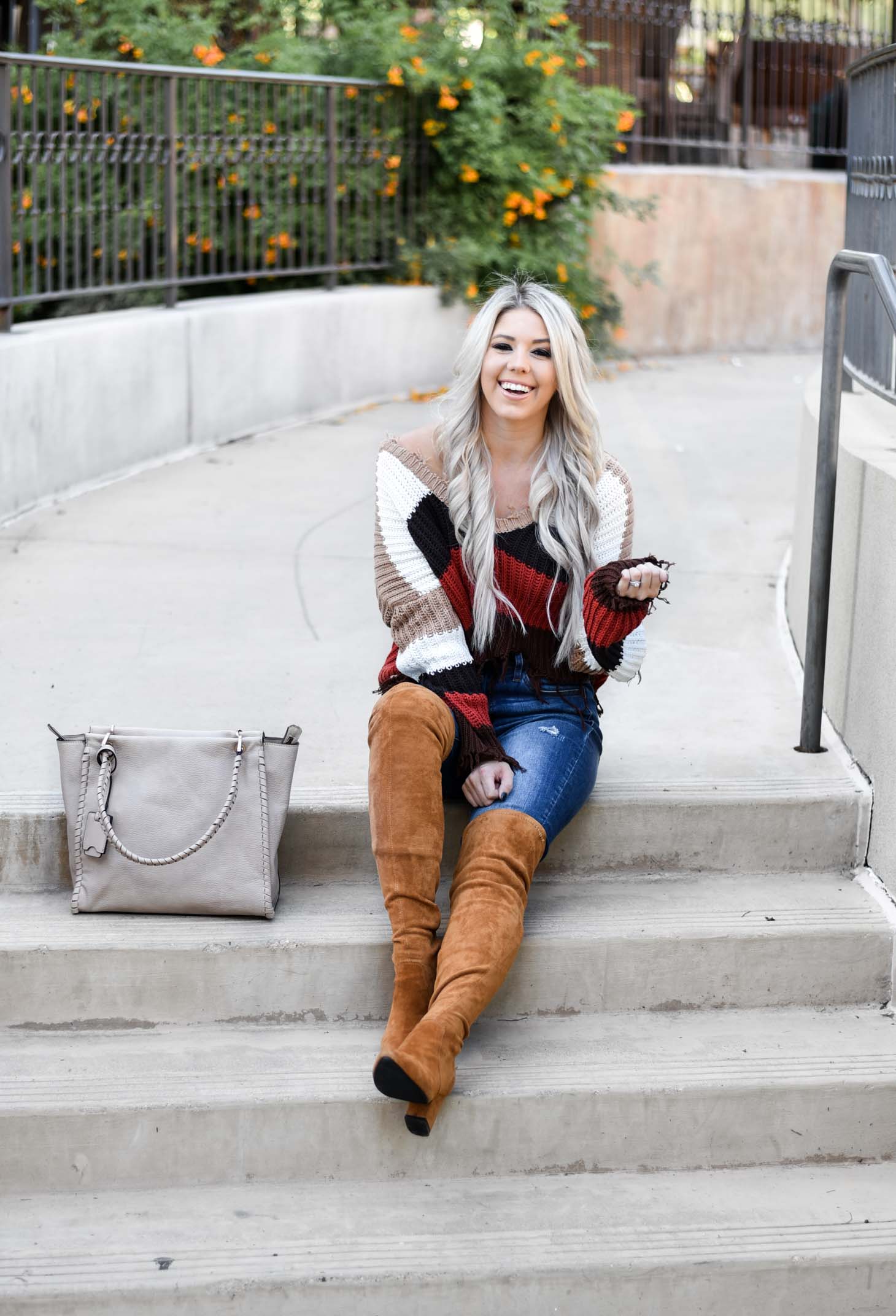 Erin Elizabeth of Wink and a Twirl shares the perfect distressed sweater and jeans from Red Dress Boutique