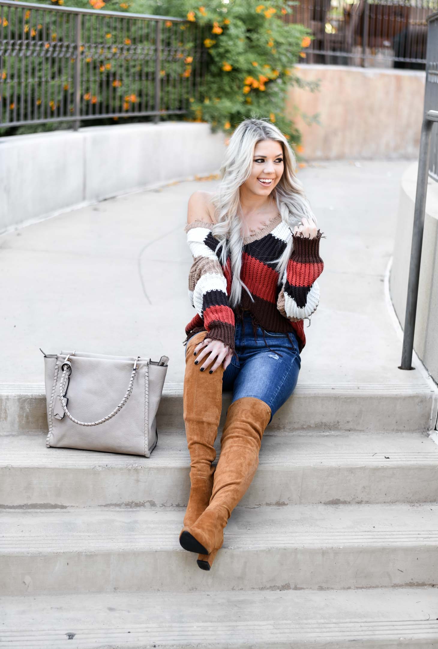 Erin Elizabeth of Wink and a Twirl shares the perfect distressed sweater and jeans from Red Dress Boutique