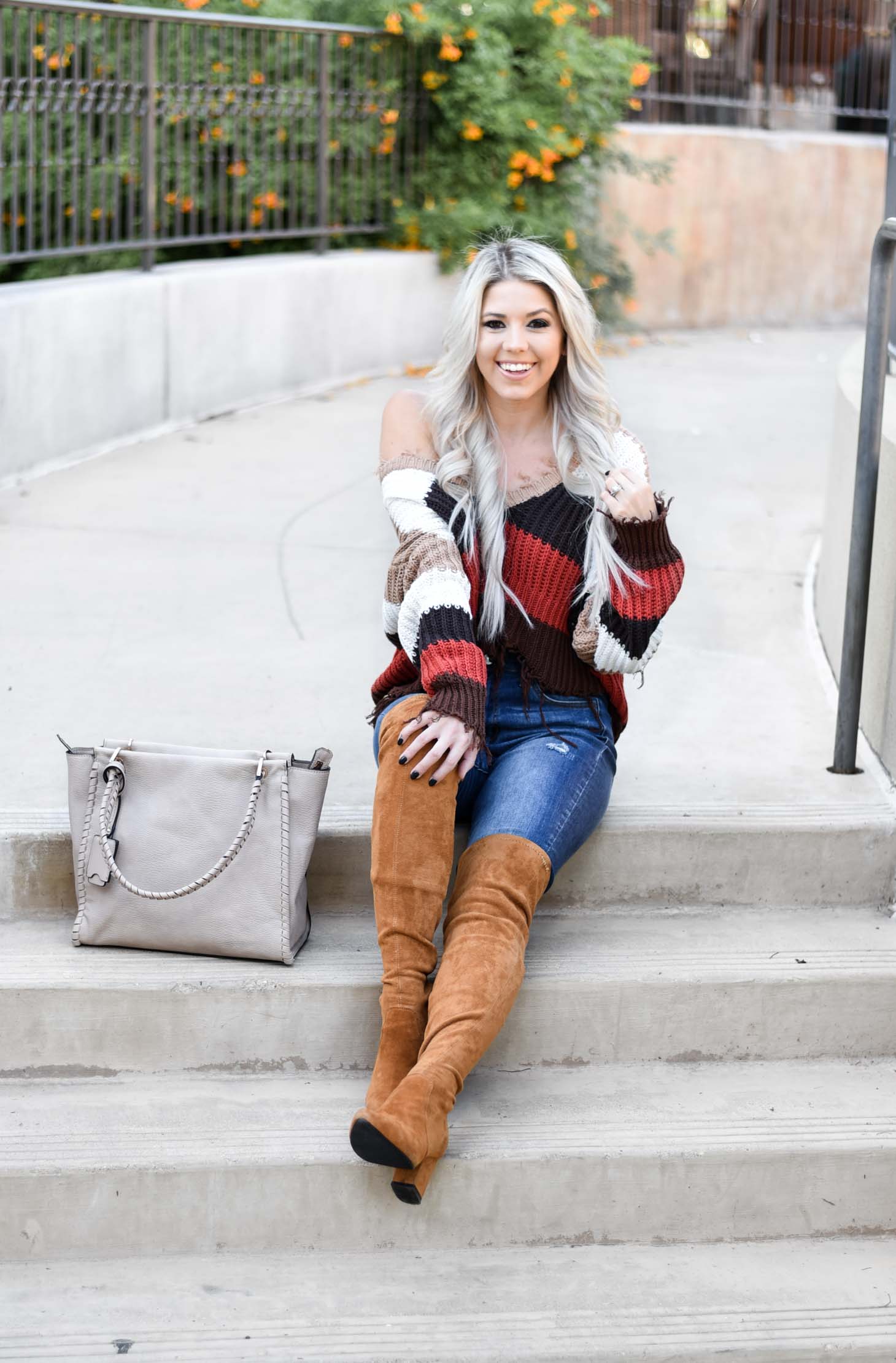 Erin Elizabeth of Wink and a Twirl shares the perfect distressed sweater and jeans from Red Dress Boutique