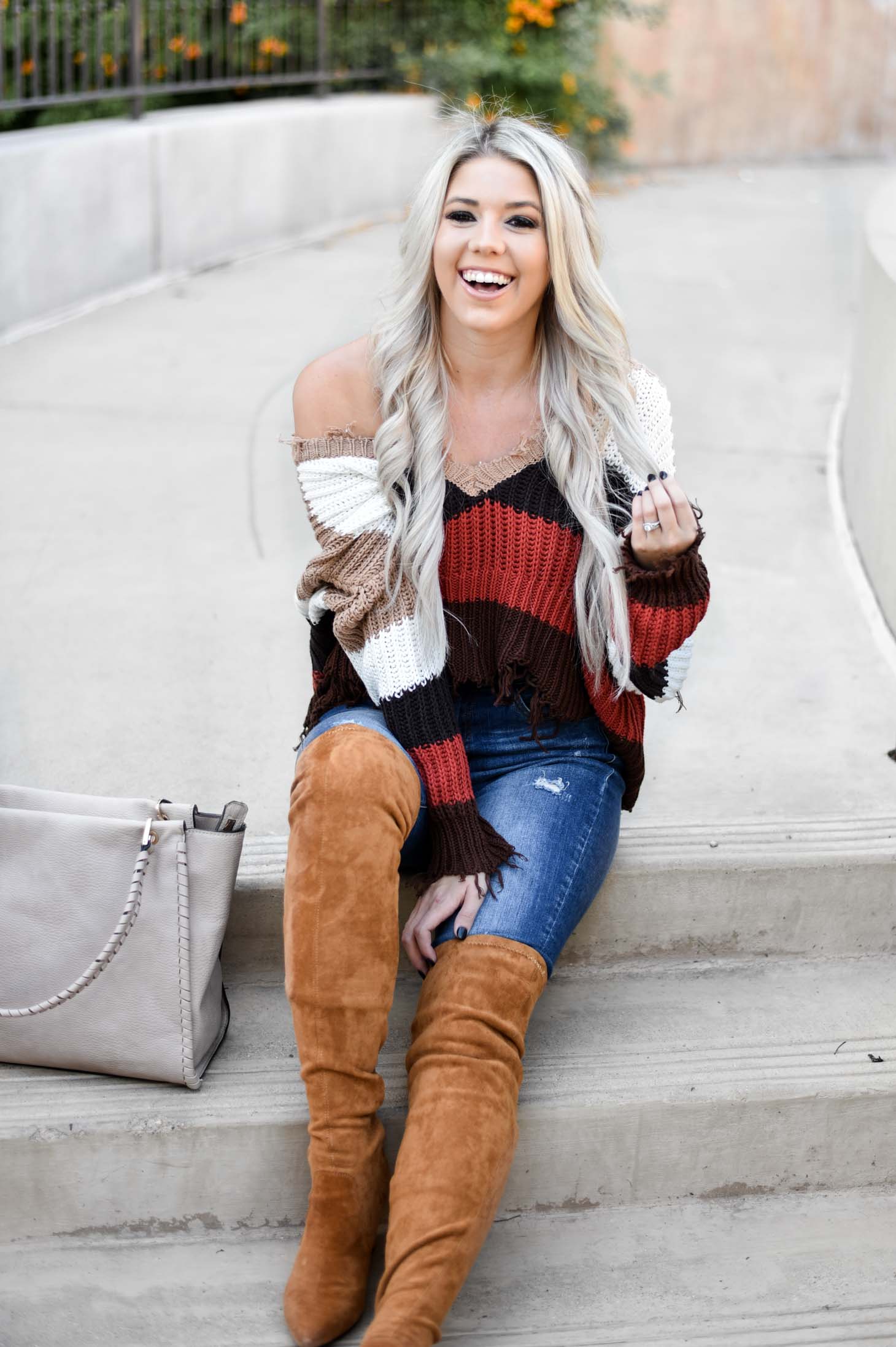 Erin Elizabeth of Wink and a Twirl shares the perfect distressed sweater and jeans from Red Dress Boutique