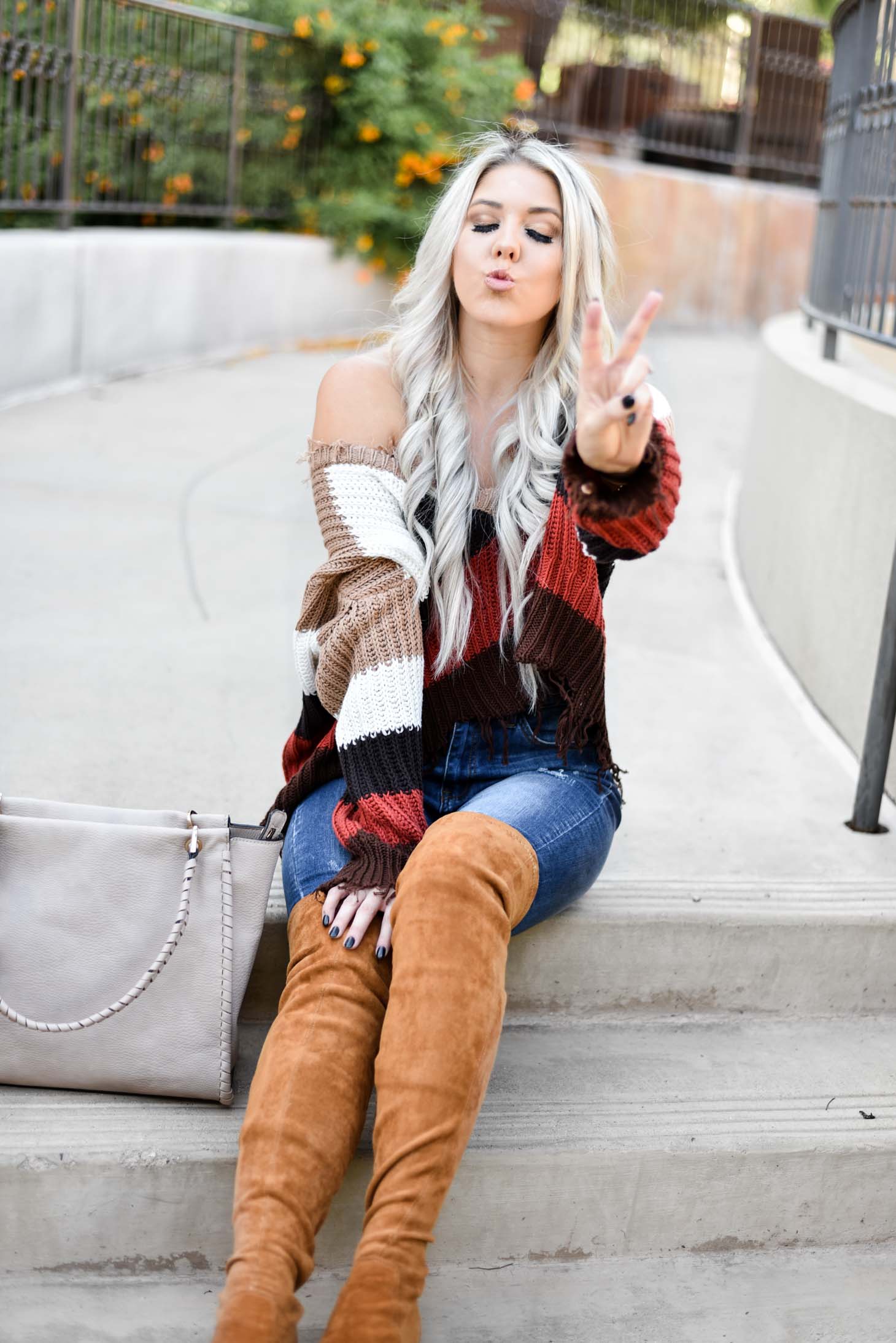 Erin Elizabeth of Wink and a Twirl shares the perfect distressed sweater and jeans from Red Dress Boutique