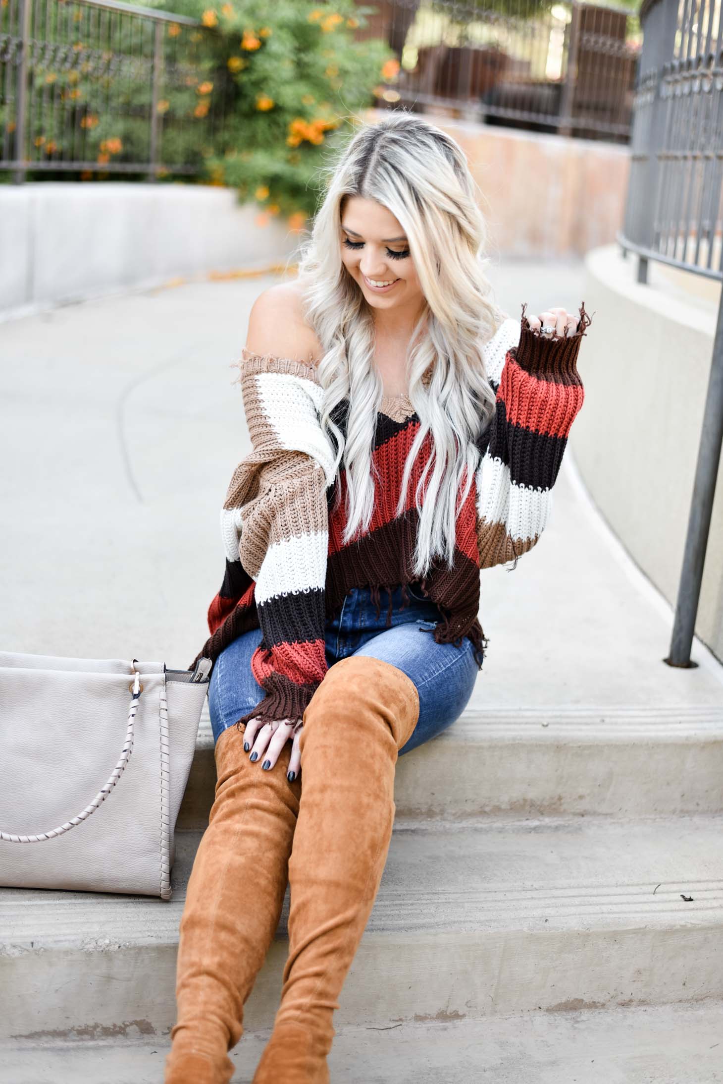Erin Elizabeth of Wink and a Twirl shares the perfect distressed sweater and jeans from Red Dress Boutique