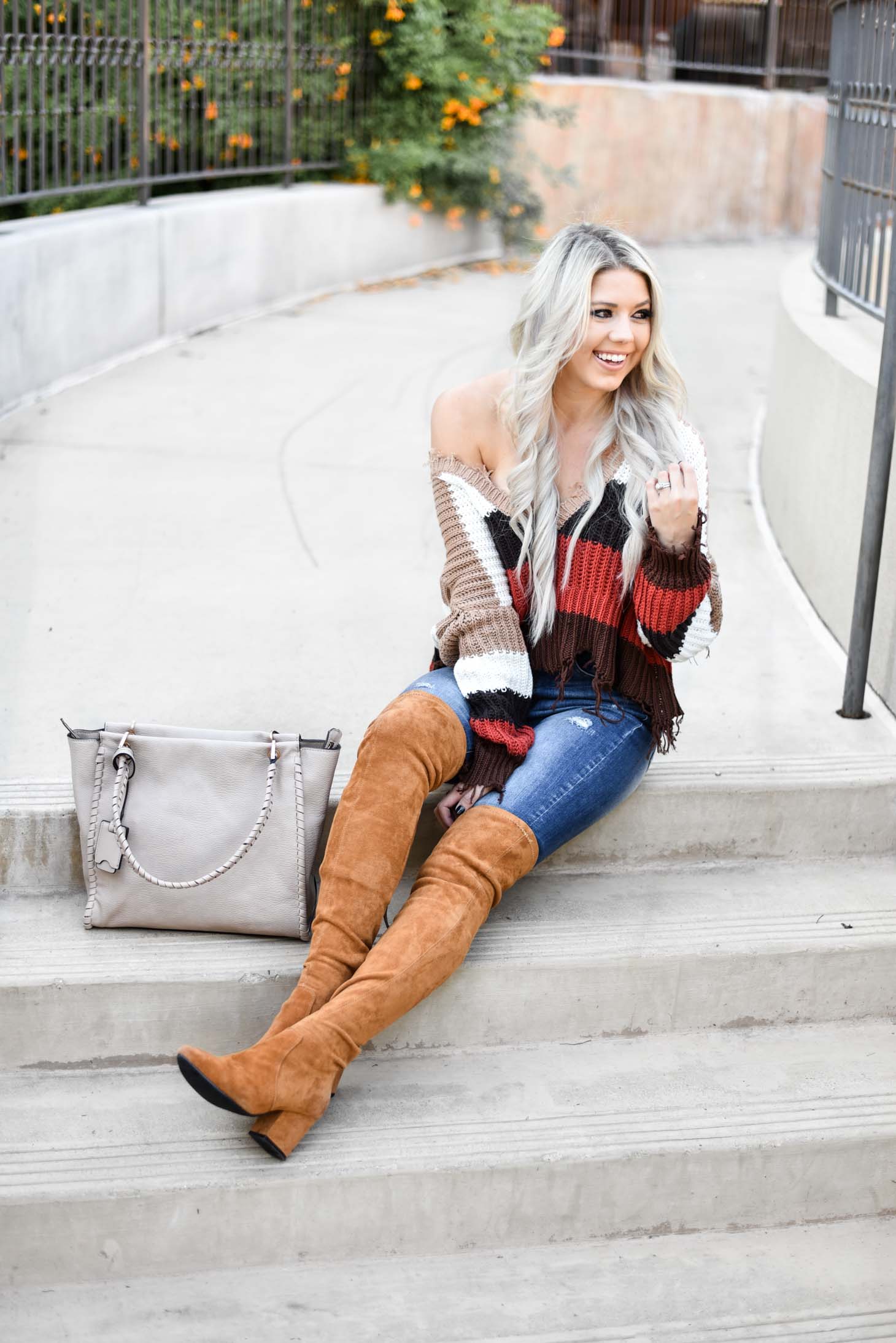 Erin Elizabeth of Wink and a Twirl shares the perfect distressed sweater and jeans from Red Dress Boutique
