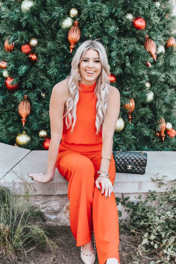 Erin Elizabeth of Wink and a Twirl share the perfect red jumpsuit from Lulus for any night out on the town