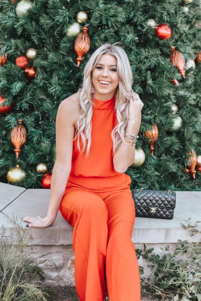 Erin Elizabeth of Wink and a Twirl share the perfect red jumpsuit from Lulus for any night out on the town