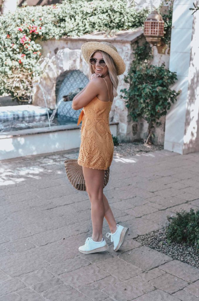Erin Elizabeth of Wink and a Twirl shares the perfect yellow crochet-detailed cutout romper from Lulus