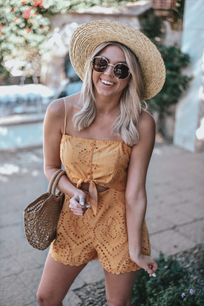 Erin Elizabeth of Wink and a Twirl shares the perfect yellow crochet-detailed cutout romper from Lulus