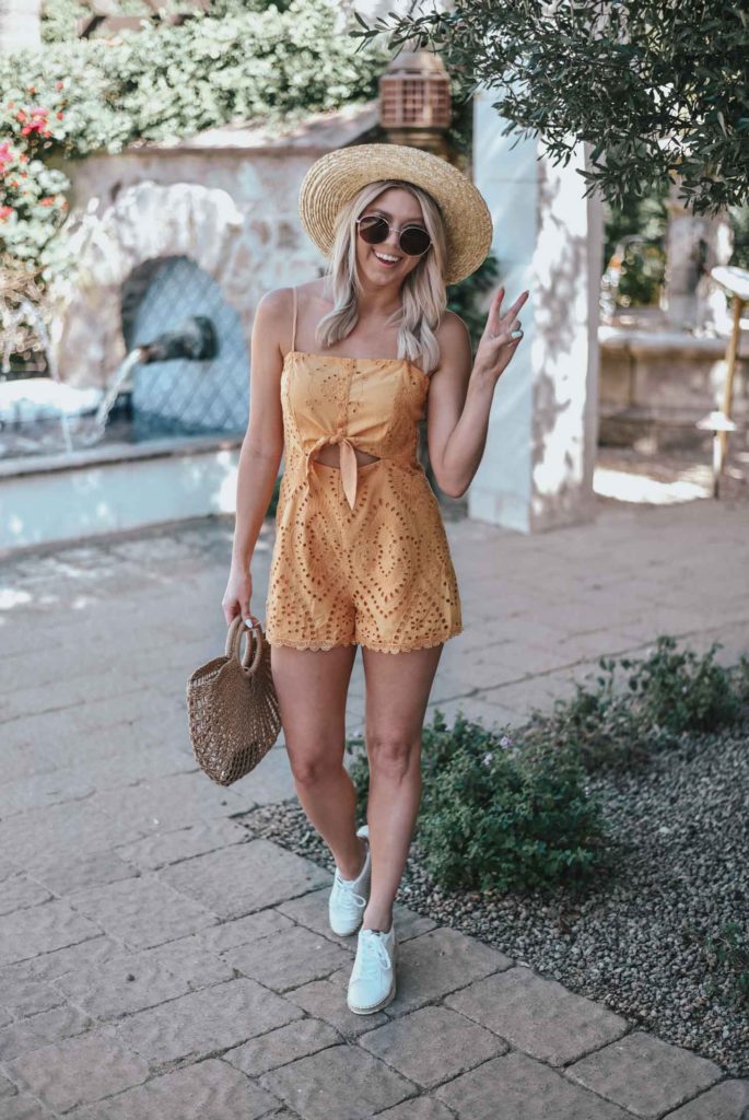 Erin Elizabeth of Wink and a Twirl shares the perfect yellow crochet-detailed cutout romper from Lulus