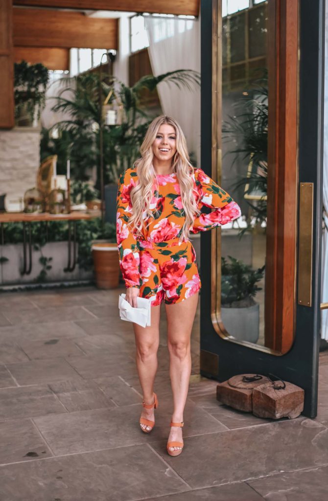 Erin Elizabeth of Wink and a Twirl shares the perfect floral romper and orange platform heels from Lulus