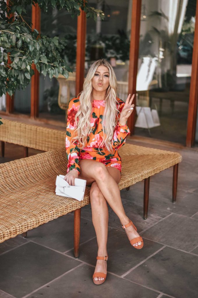 Erin Elizabeth of Wink and a Twirl shares the perfect floral romper and orange platform heels from Lulus